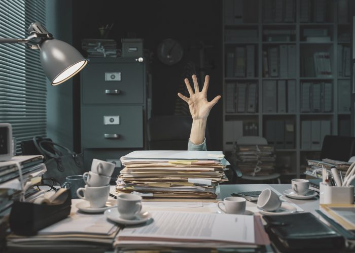 Office worker overwhelmed with paperwork